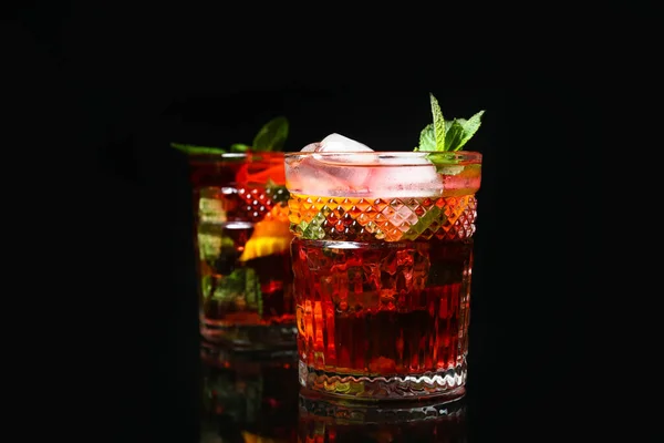 stock image Glass of tasty ice tea with lemon on dark background