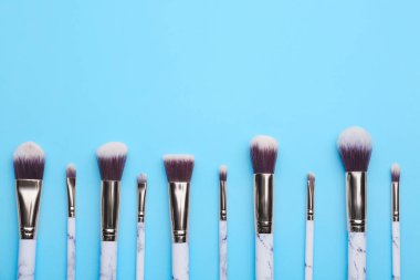 Renk arkaplanındaki makyaj fırçaları