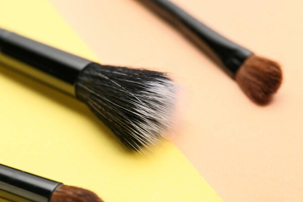 Makeup brushes on color background