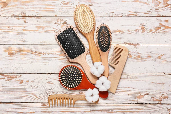 Composition Hair Brushes Combs Cotton Flowers Light Wooden Background — Stock Photo, Image