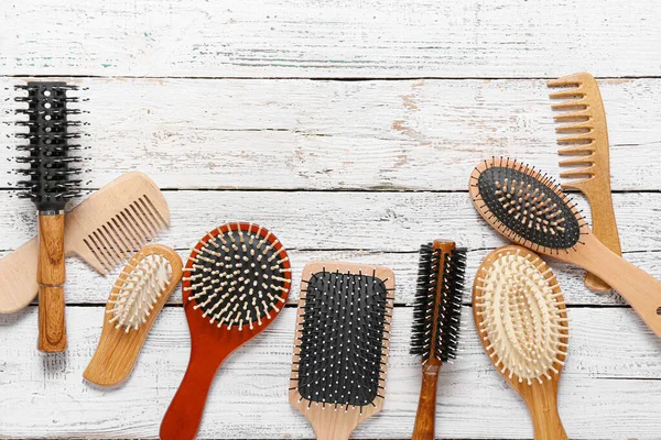 Different Hair Brushes Combs Light Wooden Background — Stock Photo, Image