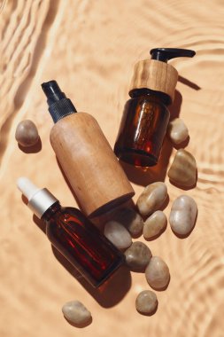 Renkli arka planda suda kozmetik ürünleri ve taşlar