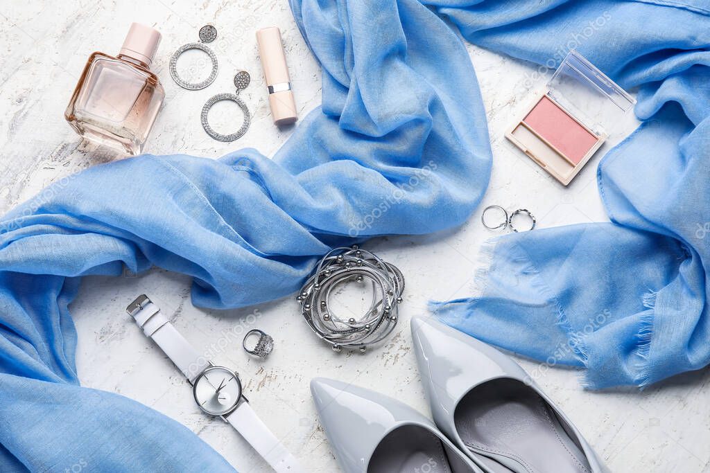 Set of female accessories and cosmetics on light background