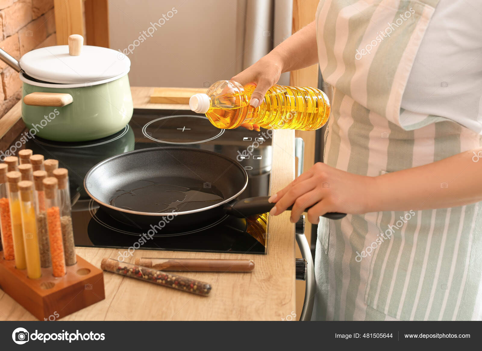 Woman Pouring Sunflower Oil Frying Pan Kitchen Stock Photo by ©serezniy