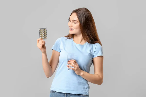 Young Woman Fish Oil Pills Light Background — Stock Photo, Image