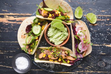 Tako ve lezzetli guacamole ile kompozisyon koyu ahşap arka planda.