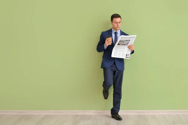 Young Businessman Cup Coffee Reading Newspaper Color Wall — Stock Photo, Image