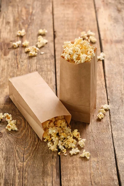 Paper Bags Tasty Popcorn Wooden Background — Stock Photo, Image