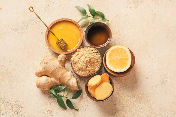 Healthy tea with ginger, lemon and honey on light background