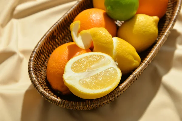 Wicker Basket Healthy Citrus Fruits Light Fabric Background Closeup — Stock Photo, Image