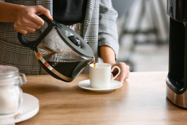 Mutfakta kahve yapan genç bir kadın, yakın plan.