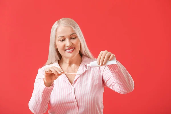 Mature Woman Brushing Teeth Color Background — Stock Photo, Image
