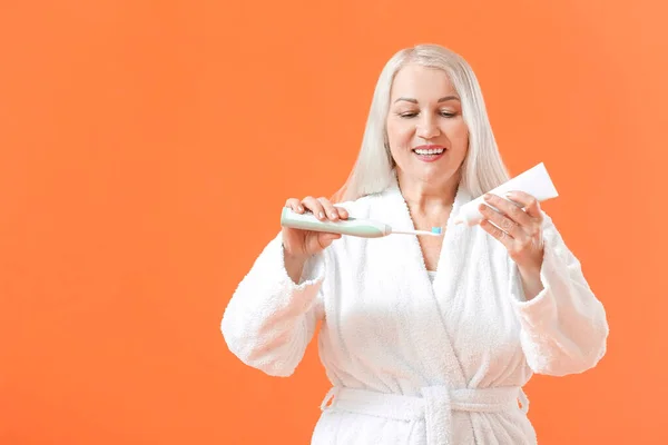 Mature Woman Brushing Teeth Color Background — Stock Photo, Image