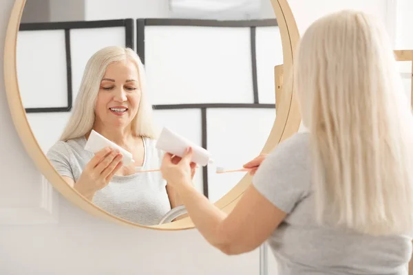 Mature Woman Brushing Teeth Home — Stock Photo, Image