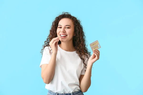 Young Woman Taking Fish Oil Pill Color Background — Stock Photo, Image