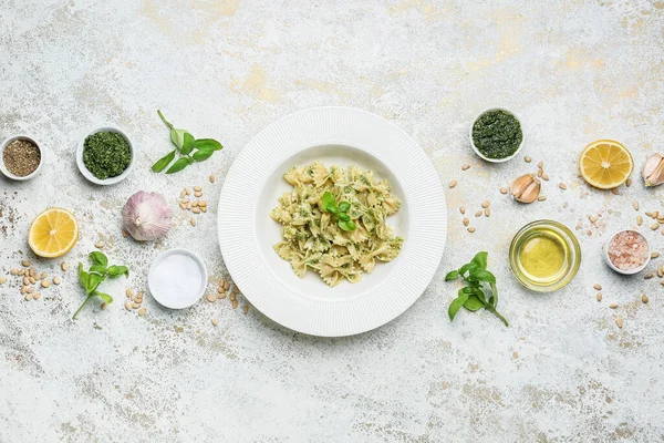 Plate Tasty Pesto Pasta Ingredients Light Background — Stock Photo, Image