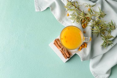 Arka planda bir bardak sağlıklı deniz dikenli çay.