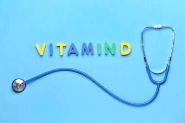 Renk arkaplanında steteskop bulunan metin VITAMIN D
