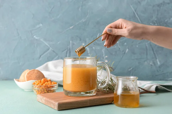 Woman Adding Honey Healthy Sea Buckthorn Tea Cup — Stock Photo, Image