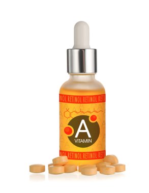 A vitamini yağı ve beyaz arka planda haplar.