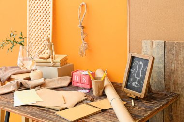 Tailor's workplace and cube calendar with date MARCH 8 near color wall in room