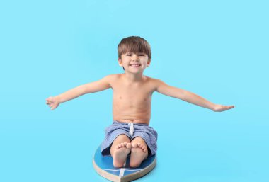 Renkli sörf tahtası olan şirin bir çocuk.