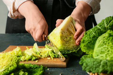 Masada taze lahana kesen kadın, yakın plan.