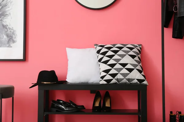 Interior of stylish hallway with shoes stand