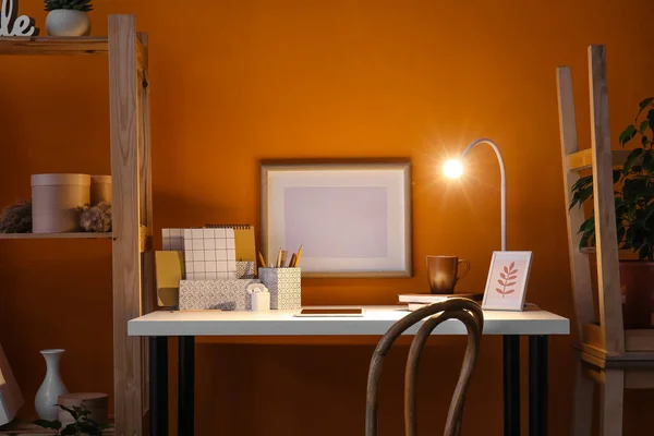 Modern Arbetsplats Med Surfplatta Och Glödande Lampa Nära Färgvägg — Stockfoto