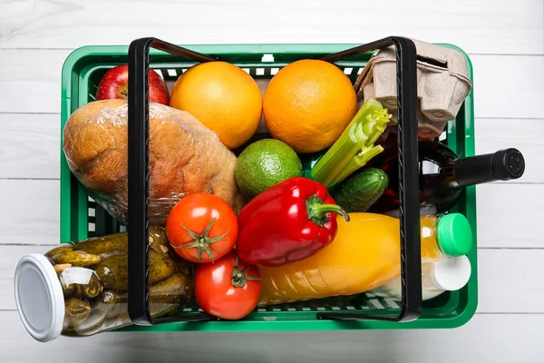 Shopping basket with food on white background