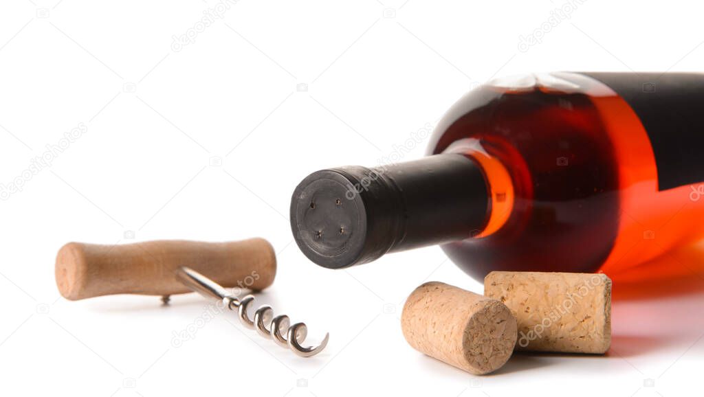 Bottle of exquisite wine and corkscrew on white background, closeup