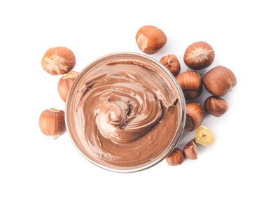 Lezzetli çikolata ezmeli kase ve beyaz arka planda fındık.