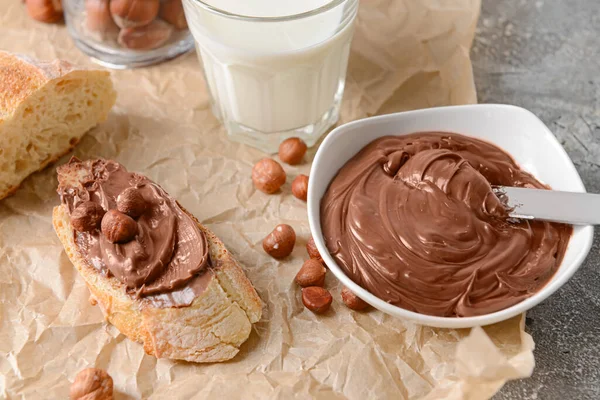 Bowl Tasty Chocolate Paste Hazelnuts Parchment — Stock Photo, Image
