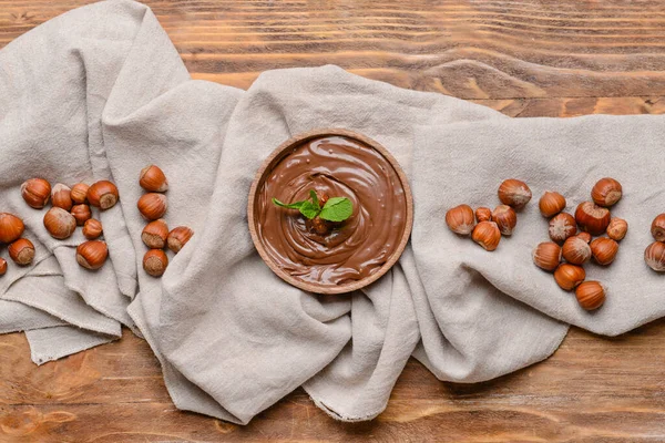 Bowl Tasty Chocolate Paste Hazelnuts Wooden Background — Stock Photo, Image