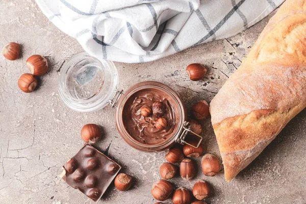 Jar Tasty Chocolate Paste Hazelnuts Grey Background — Stock Photo, Image