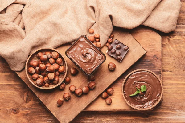Bowl Tasty Chocolate Paste Hazelnuts Wooden Background — Stock Photo, Image