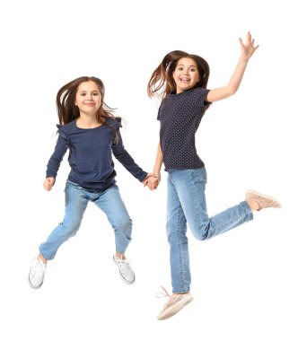 Beyaz arka planda atlayan tatlı ikiz kızlar.