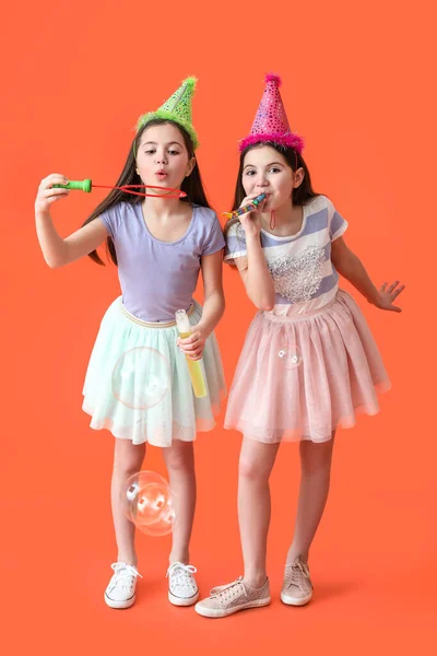 Cute Twin Girls Party Hats Blowing Soap Bubbles Color Background — Stock Photo, Image