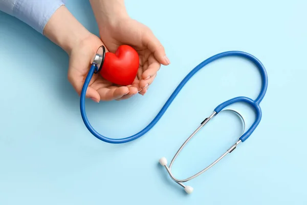 Female Hands Red Heart Stethoscope Color Background — Stock Photo, Image