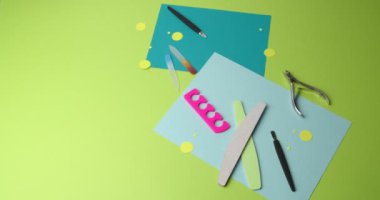 Set for manicure and pedicure on color background, video with stop motion effect
