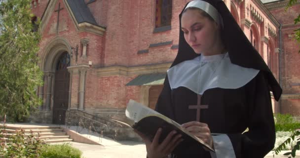 Young Nun Reading Bible Outdoors Monastery — Stock Video