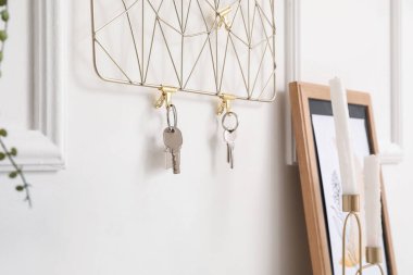 Key holder hanging on light wall, closeup