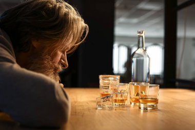 Drunk senior man late in evening at home