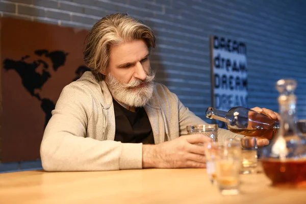 Senior Man Pouring Drink Glass Late Evening Home — Stock Photo, Image