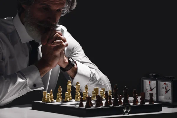 Senior Man Playing Chess Dark Background — ストック写真