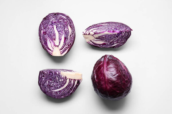 Pieces of fresh purple cabbage on light background