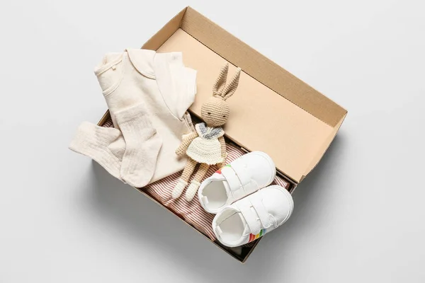 Box Baby Clothes Shoes Knitted Toy Light Background — Foto de Stock