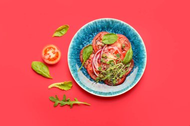 Plate with tasty tomato carpaccio on color background