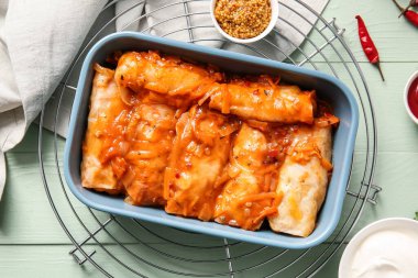 Lezzetli lahana sarmalarıyla ahşap arka planda pişirme yemeği.