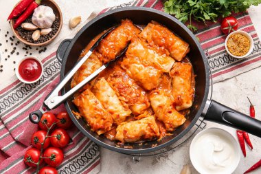 Hafif arka planda lezzetli lahana dürümlü kızartma tavası.